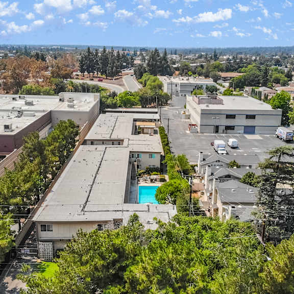 a view of a residential area with houses and a swimming pool.