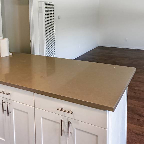 a kitchen with white cabinets and a countertop.