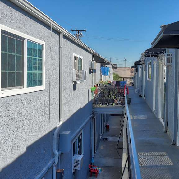 a row of houses with a blue sky in the background.