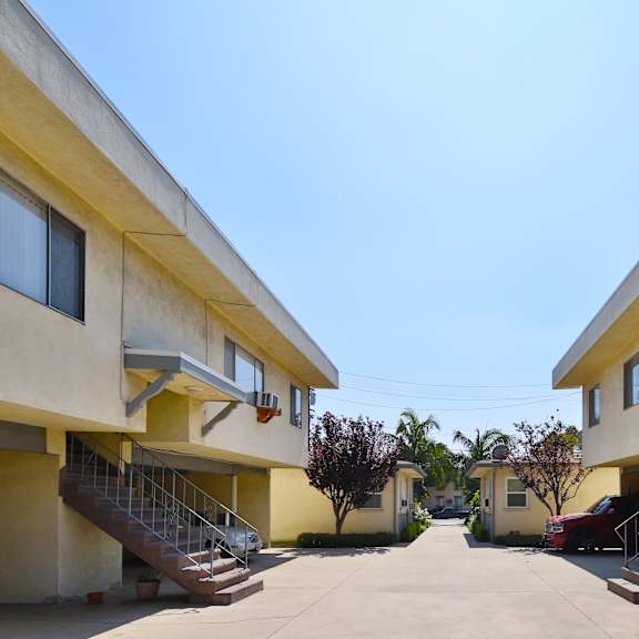 a row of houses with staircases leading to the front doors.