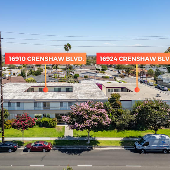 a street view of crenshaw blvd with cars parked on the side of the road.