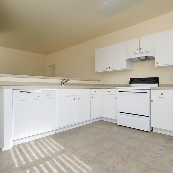 a kitchen with white appliances and cabinets.