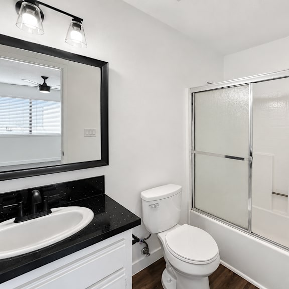 a white toilet sits next to a sink in a bathroom.