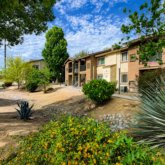 a sunny day at a residential area with houses and greenery.