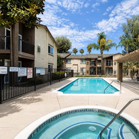 a pool in a courtyard surrounded by buildings.