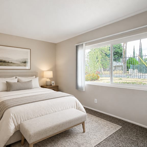a bedroom with a large bed and a painting on the wall.