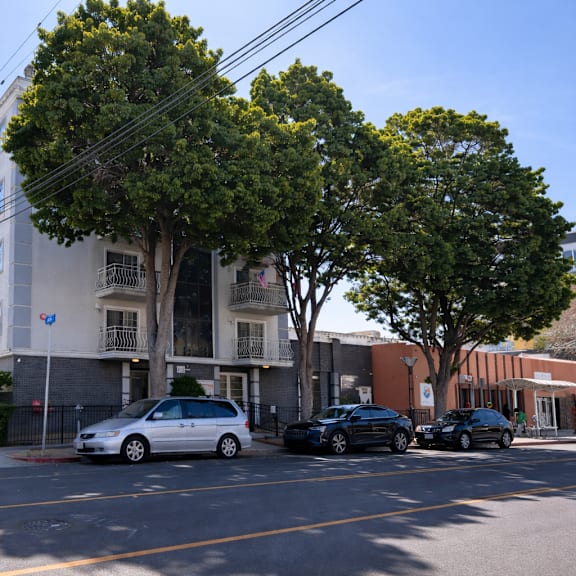 a street view with cars and buildings.
