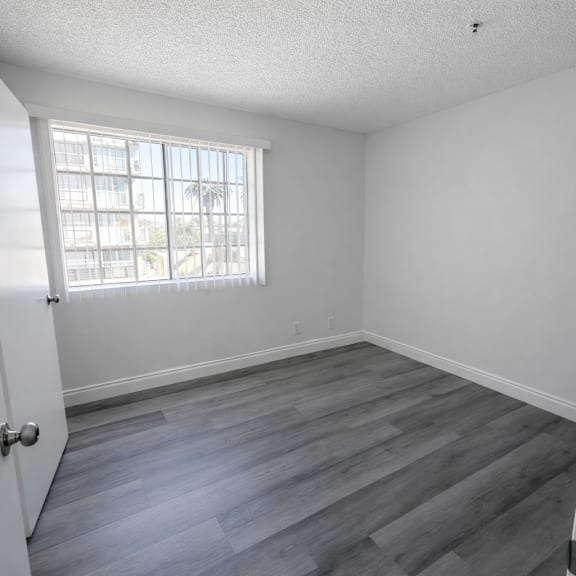 a room with a wooden floor and a window.