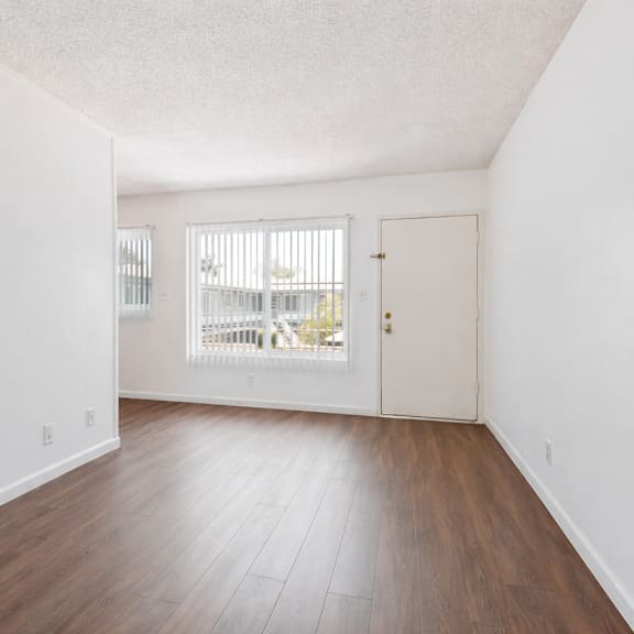 a room with wooden floors and white walls.