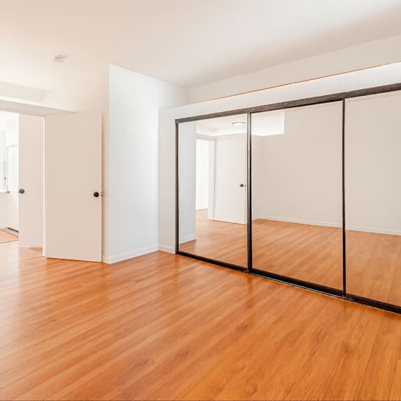 a room with wooden floors and white walls.
