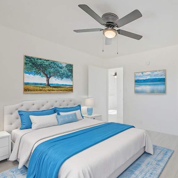 a bedroom with a large bed and a ceiling fan.