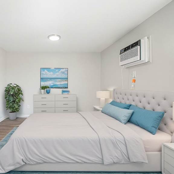 a bedroom with a bed, nightstand, and a painting on the wall.