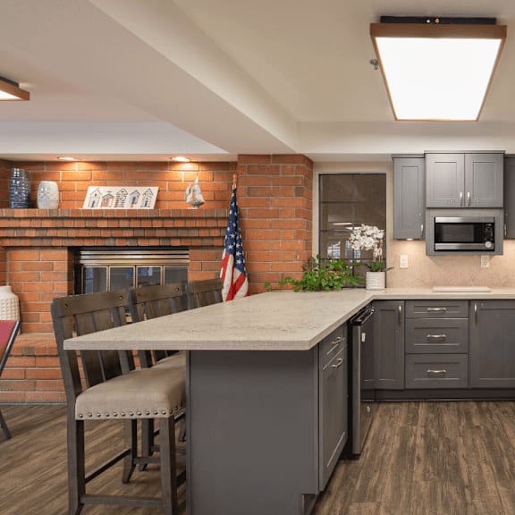 a kitchen with gray cabinets and a white counter top at huntington terrace north senior, huntington beach, 92648