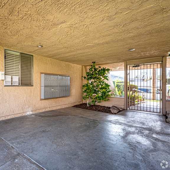 a concrete room with a door and a window.