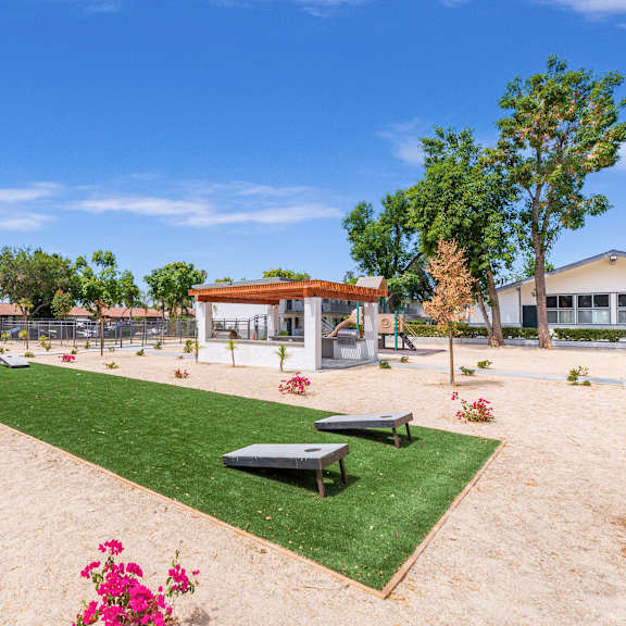 a park with a playground and a picnic table.