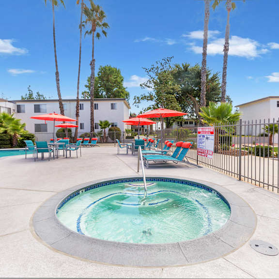 a pool with a fountain in the middle of it.