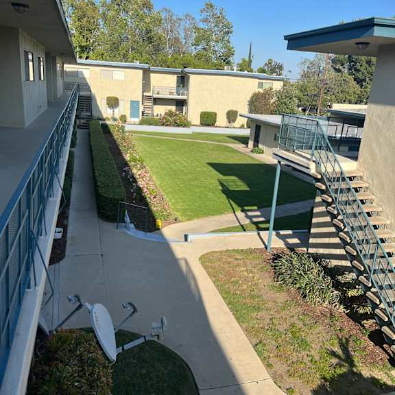 a view of a courtyard from a balcony.