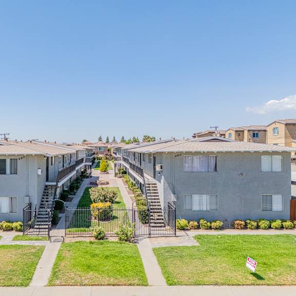 apartment complex with a staircase leading to the entrance.