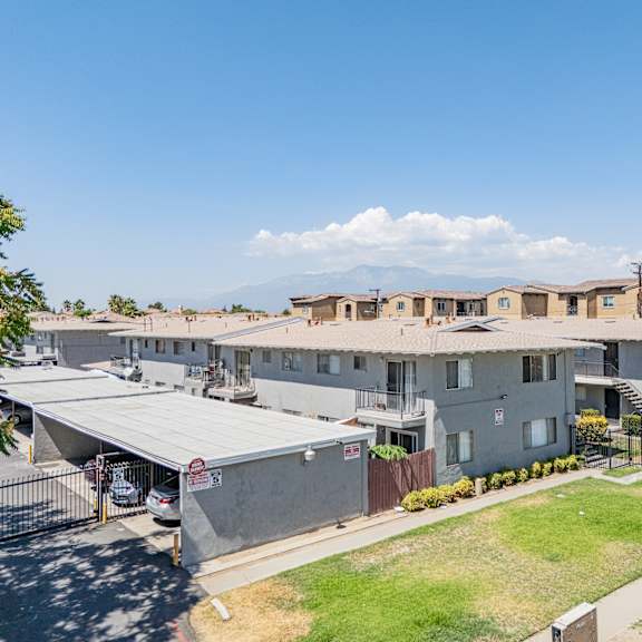 a sunny day at a residential complex with a clear blue sky.