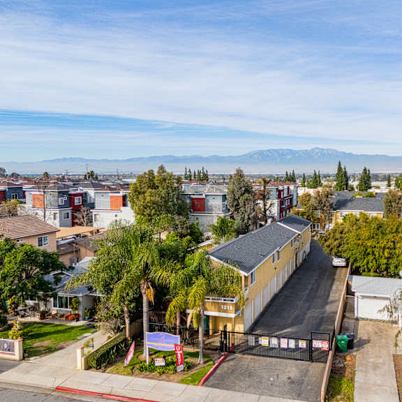 a residential area with houses and a mountain in the distance.