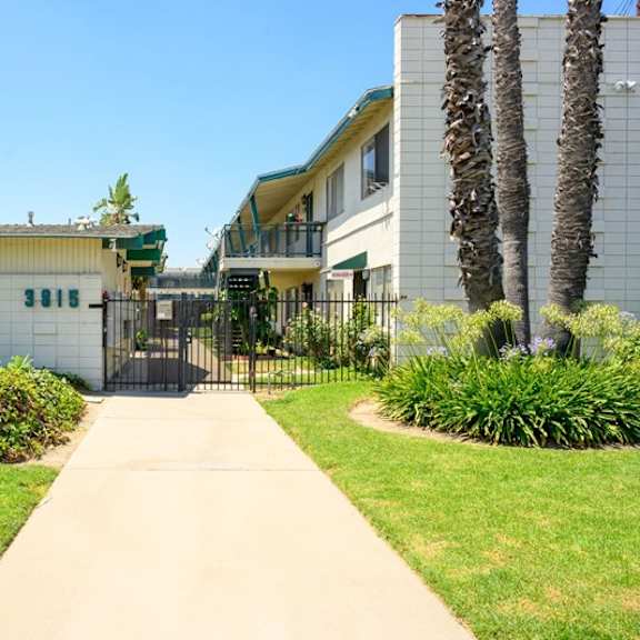 a walkway leads to a building with a sign that says "fashion lane.".