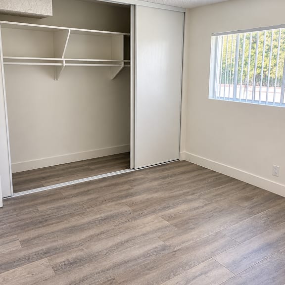 a room with a closet and a window.