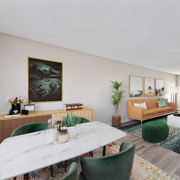 a living room with a white marble table and green chairs.