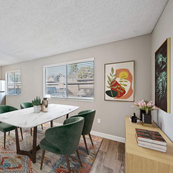 a dining room with a table and chairs.