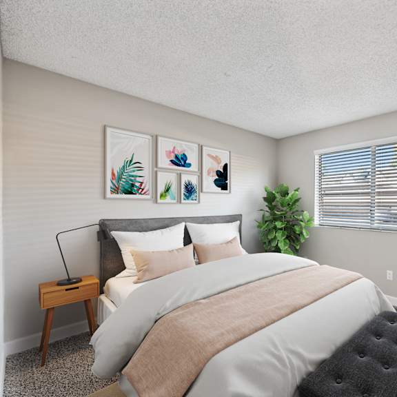 a bedroom with a large bed and a plant on the windowsill.