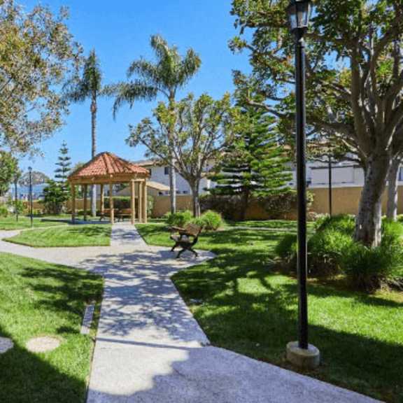 a pathway through a park with a gazebo and trees at huntington terrace north senior, california