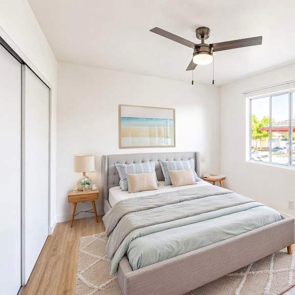 a bedroom with a large bed and a ceiling fan.