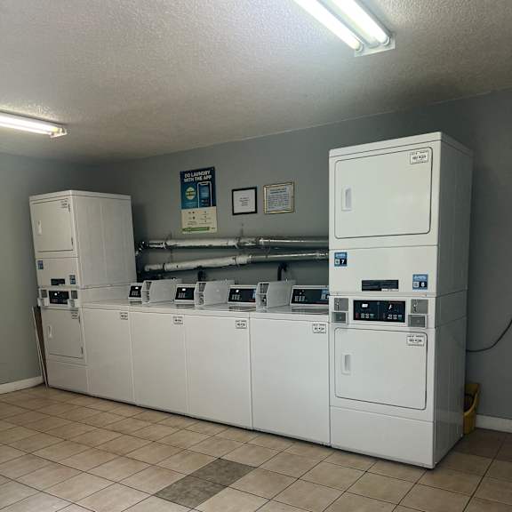 a wall of tiles with a white electrical panel mounted on it.