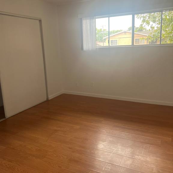a room with a window and wooden walls.
