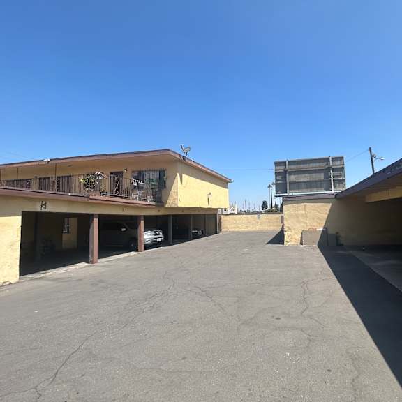a clear blue sky is visible through the openings of a concrete structure.
