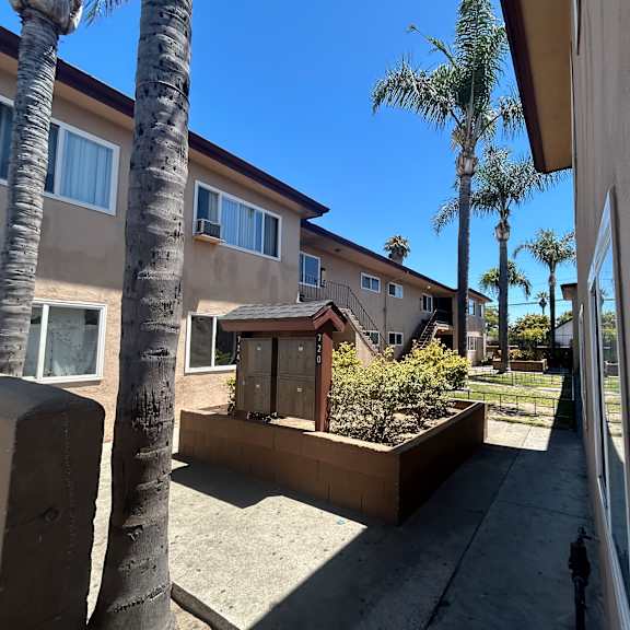 a view of a row of houses with a clear blue sky.