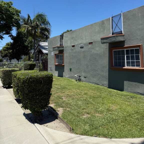a building with a green lawn in front.