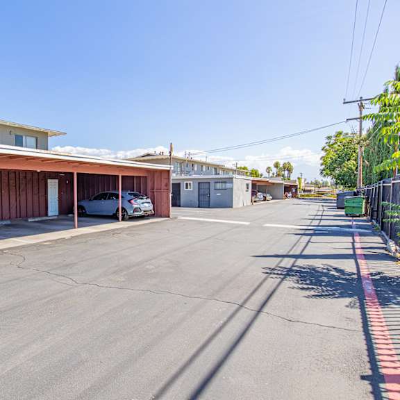 a parking lot with a building in the background.