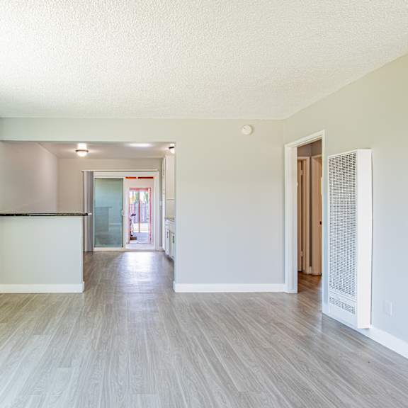 a room with a wooden floor and white walls.