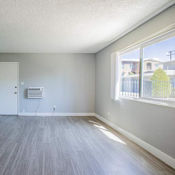 a room with a grey floor and a white door.