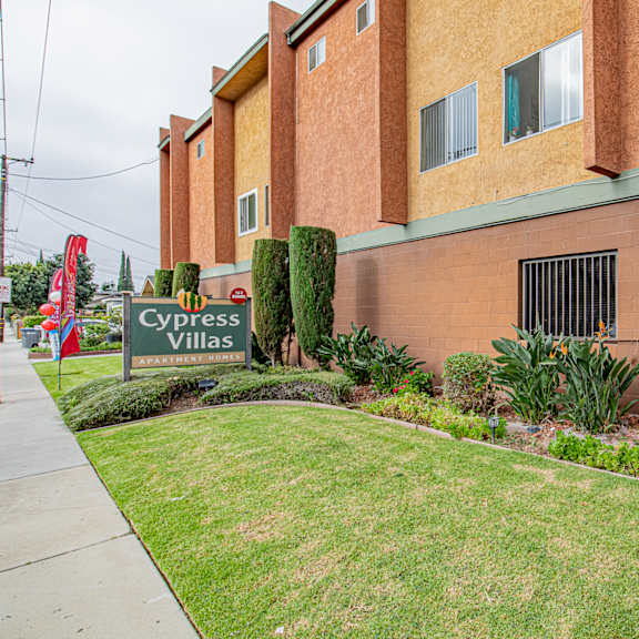 a building with a sign that says cypress villas.