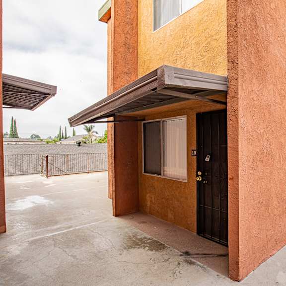 a house with a brown stucco exterior and a black door.