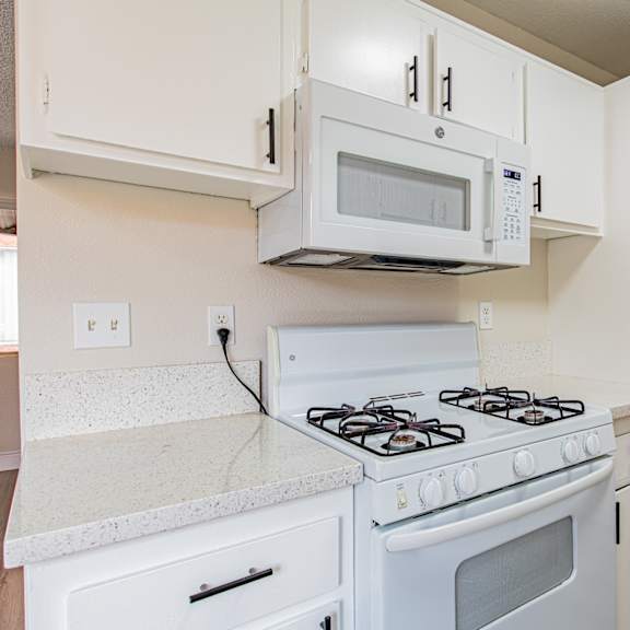 a white stove and microwave in a kitchen.