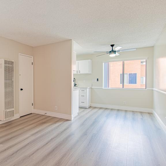 a room with a staircase and a ceiling fan.