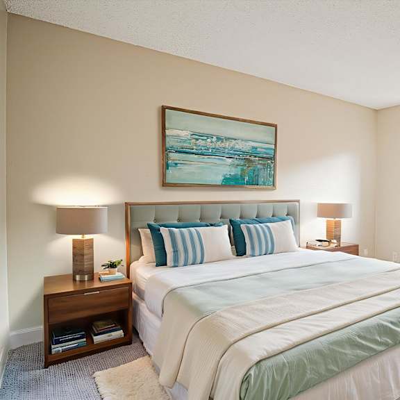a bedroom with a large bed and a painting on the wall.