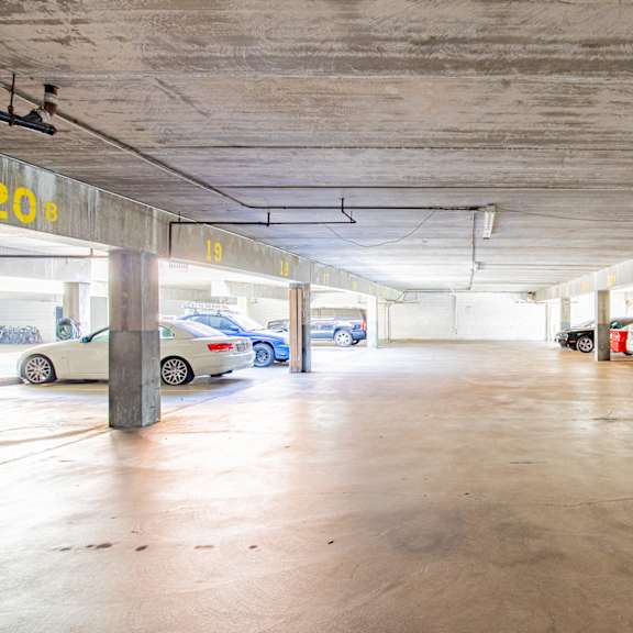 a parking garage with cars parked in it.