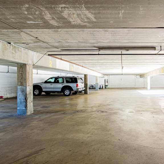 a white truck is parked in a spacious, empty parking garage.