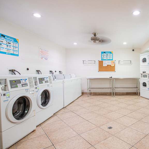 a laundromat with a row of washers and dryers.