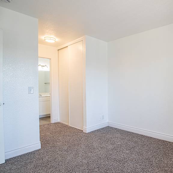 a room with a carpeted floor and white walls.