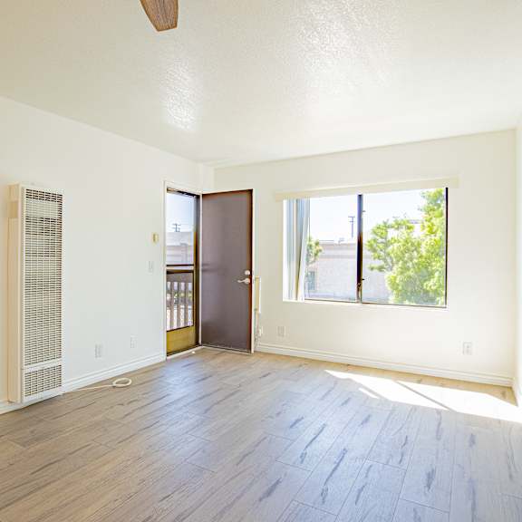 a room with a wooden floor and a ceiling fan.