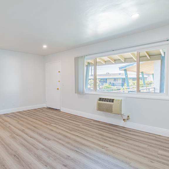a room with a window and a ceiling fan.